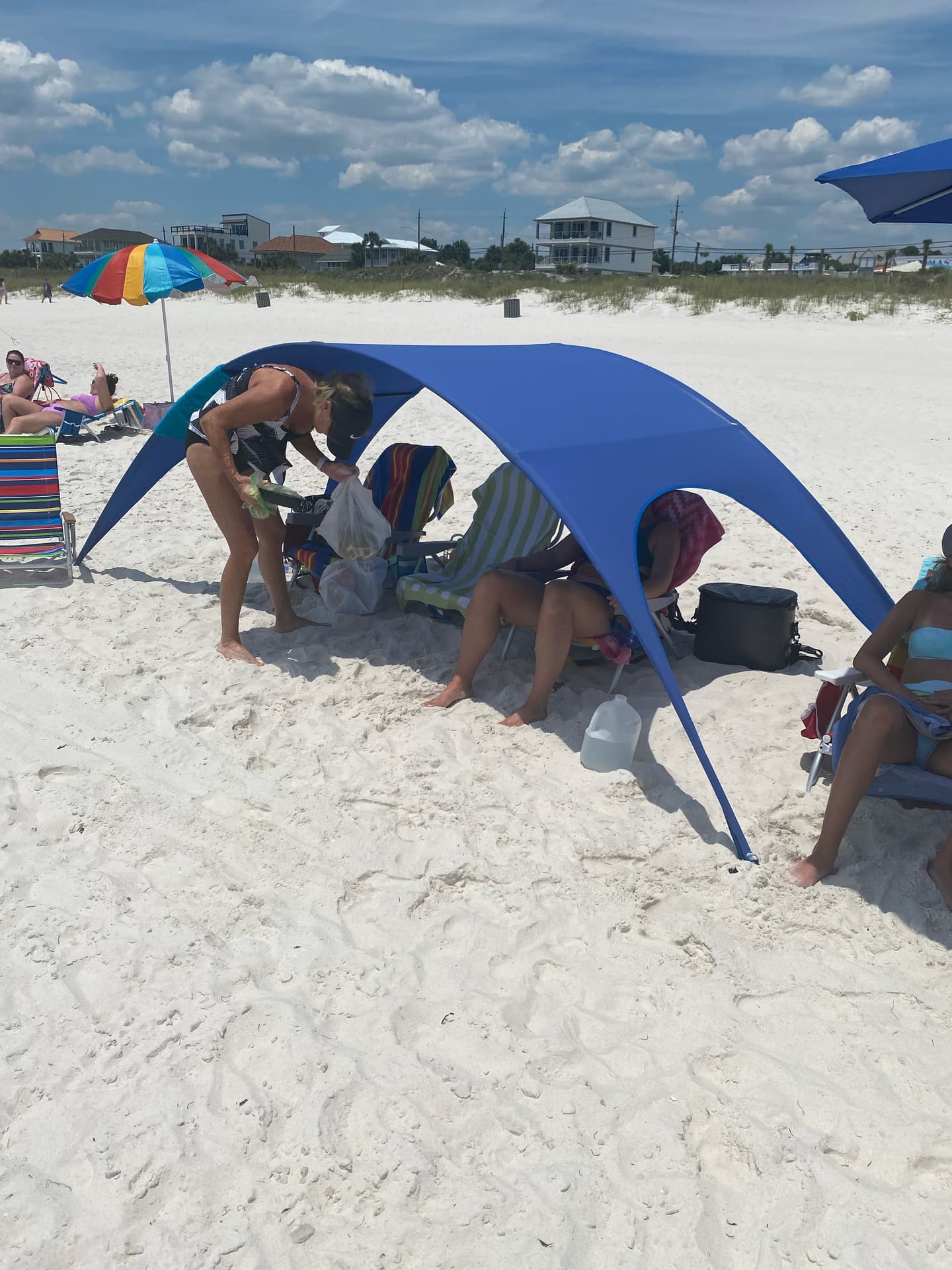 Shady Baby canopy staked in beach sand providing full dome shade